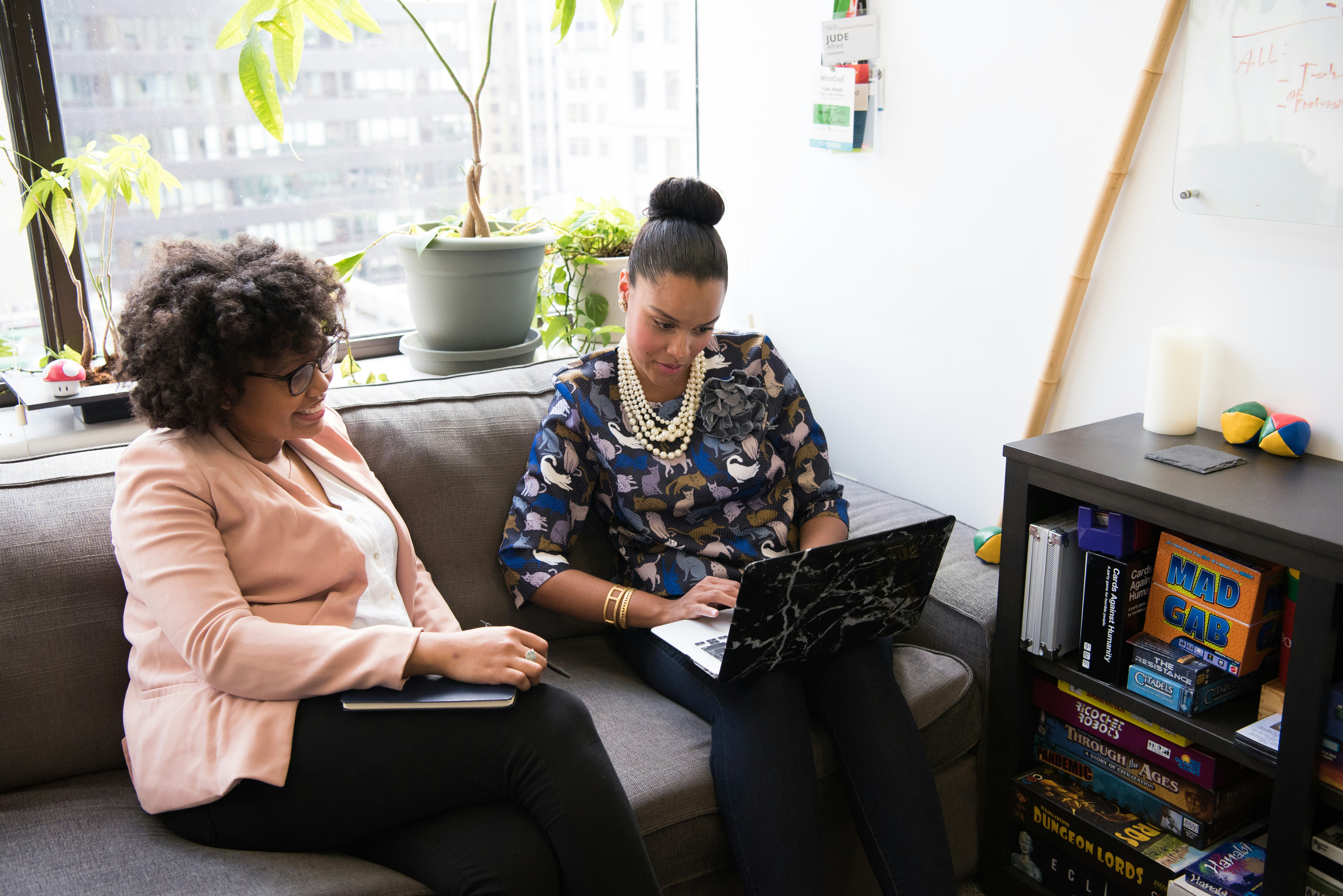 two woman working on laptop